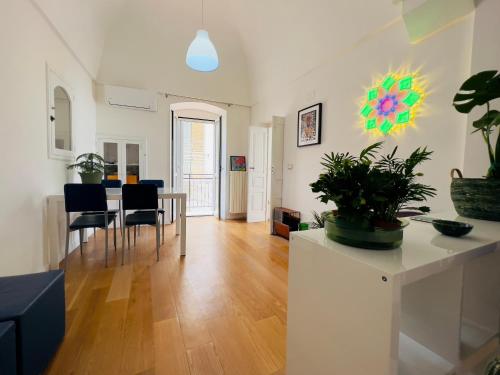 a dining room and living room with a table and chairs at Q40 Ostuni in Ostuni