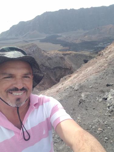 a man with a hat on top of a mountain at chez albino guest house in São Filipe