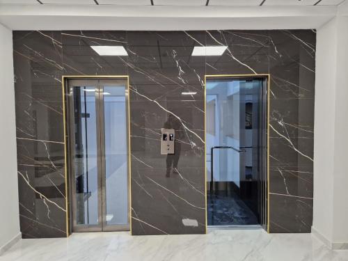 a lobby with two mirrors and a person in the reflection at Alvina apartment hotel in Tsaghkadzor