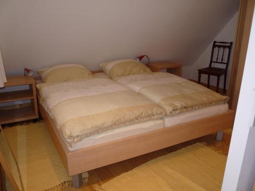 a bed with two pillows on it in a room at Zum Schwarzen Stiefel- Ferienwohnung Atelierhaus in Liepe