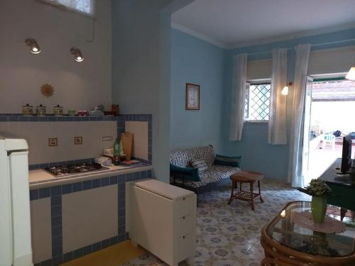a living room with a kitchen with a stove top oven at Dimora di Enea - Gaeta Medievale in Gaeta