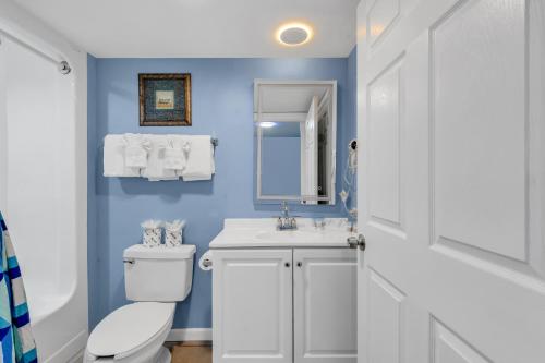 a bathroom with a white toilet and a sink at Atlantica Towers - Beach Front Condo w Pools in Myrtle Beach