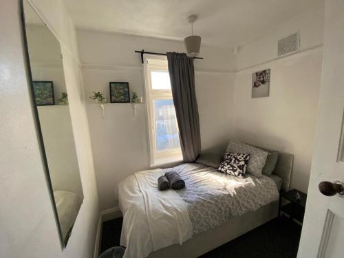 a small bedroom with a bed and a window at Peaceful stay Derby Single Room in Derby