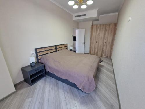 een slaapkamer met een bed, een dressoir en een koelkast bij Alvina apartment Tsaghkadzor in Tsachkadzor