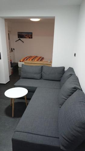 a living room with a couch and a table at Ferienwohnung Haus Merle in Jestädt