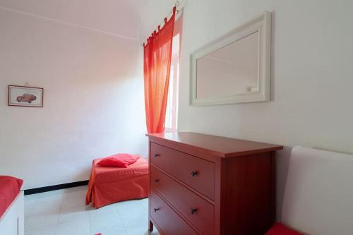 a bedroom with a red dresser and a red bed at Beatrice Nel centro di Levanto in Levanto