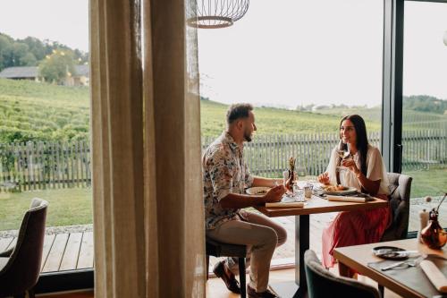 a man and woman sitting at a table in a restaurant at Ratscher Landhaus in Ratsch an der Weinstraße
