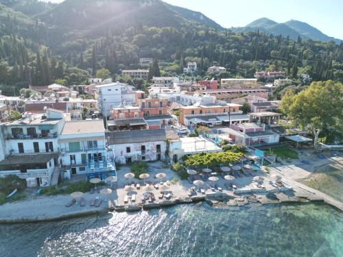 an aerial view of a town on the water at Avra Budget Beach Rooms in Benitses