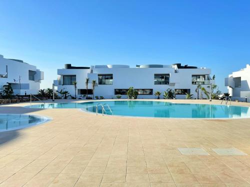 a large swimming pool in front of a building at Casa Domino in Villaverde