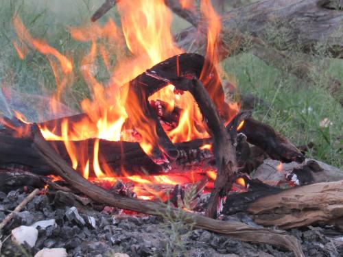 a fire is burning in a pile of rubble at Ibenstein Safaris in Dordabis