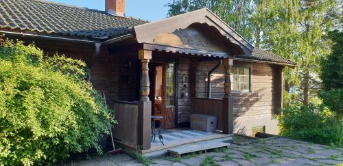 a small house with a porch and a wooden door at Villa Vy in Rättvik