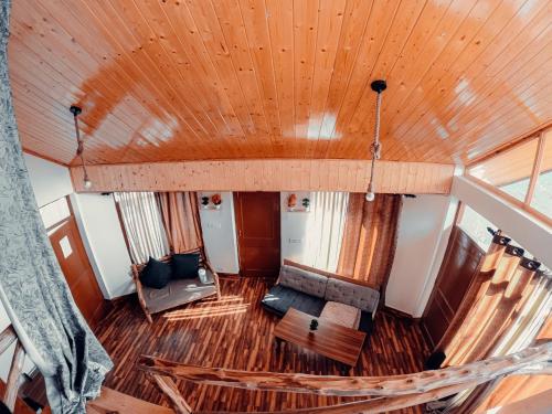 an overhead view of a living room with a couch at Roamate Hostel, Old Manali in Manāli