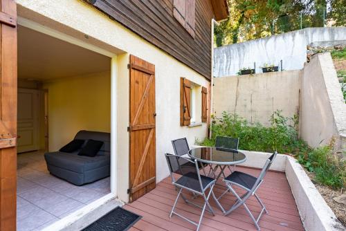 a patio with a table and chairs on a deck at A sérénita in Carbuccia