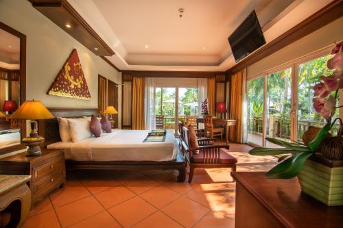 a bedroom with a bed and a living room at Avalon Beach Resort in Pattaya South