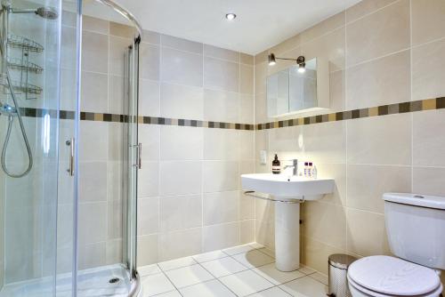 a bathroom with a shower and a toilet and a sink at Luxury Studio Suite in Stamford Centre - The Old Seed Mill - B in Stamford