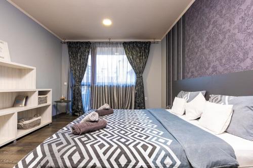 a bedroom with a large bed with stuffed animals on it at Dufti Home in Plovdiv Center & Old Town / Kapana in Plovdiv