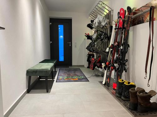a hallway with a room filled with lots of ski equipment at Astrid's Pension in Winterberg