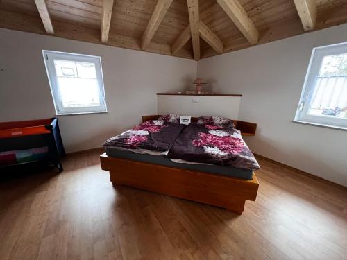 a bedroom with a bed in a room with wooden floors at Villa Toskana Wohnung 2 in Wackersdorf