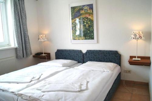 1 dormitorio con 1 cama grande y cabecero azul en Ferienwohnung 105 Haus Katharina mit Balkon, en Lauterbach
