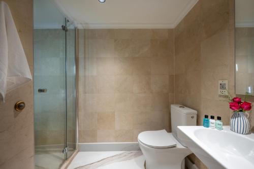 a bathroom with a shower and a toilet and a sink at Aria in Eilat