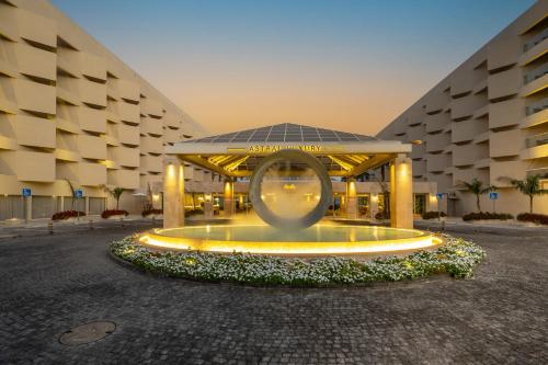 a large building with a fountain in front of it at Aria in Eilat