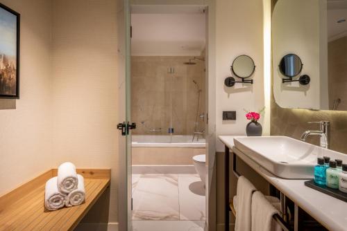 a bathroom with a sink and a toilet and a shower at Aria in Eilat