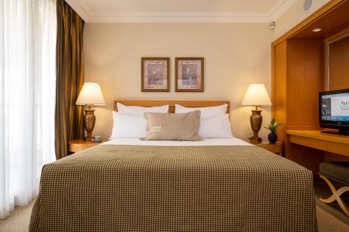 a hotel room with a bed and a television at Aria in Eilat