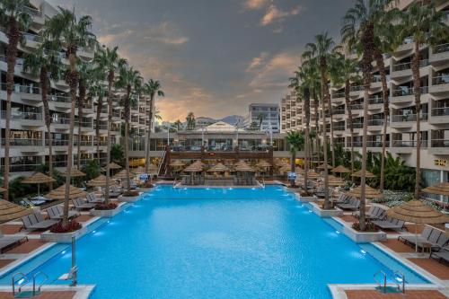 a large swimming pool with chairs and umbrellas at Aria in Eilat