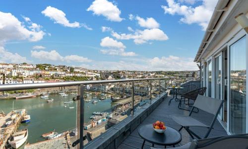 a balcony with a view of a harbor at The Penthouse in Brixham