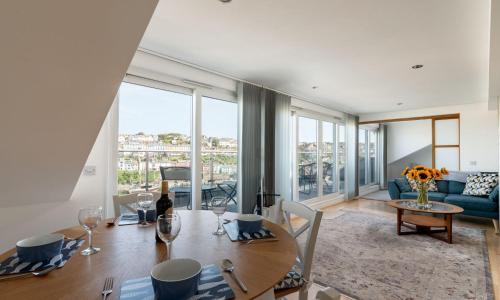 a living room with a table and a couch at The Penthouse in Brixham