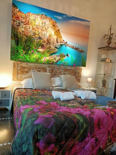 a bedroom with a large painting on the wall at Le Stanze del Principe in Genova