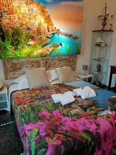 a bedroom with a bed with a painting on the wall at Le Stanze del Principe in Genova