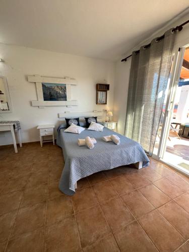 a bedroom with a bed with two pillows on it at Estudi Es Carnatge in Playa Migjorn
