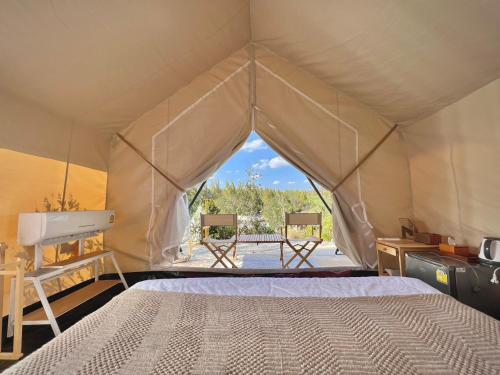 a bedroom with a bed in a tent at SOL Glamping at Khao yai in Ban Nong Makha