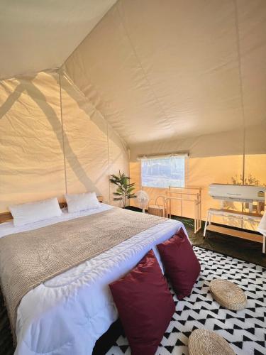 a bedroom with a bed in a tent at SOL Glamping at Khao yai in Ban Nong Makha