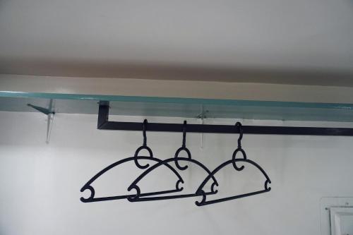 a metal rack with two bells hanging from a ceiling at Cebu Backpackers Hostel in Cebu City