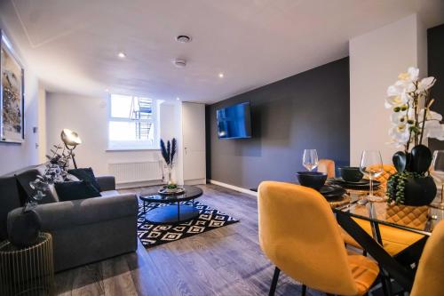 a living room with a couch and a table at York Crescent Apartments in York