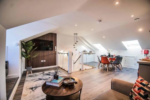 a living room with a table and a dining room at York Crescent Apartments in York
