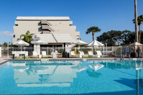 a large swimming pool in front of a hotel at Palazzo Lakeside Hotel in Kissimmee