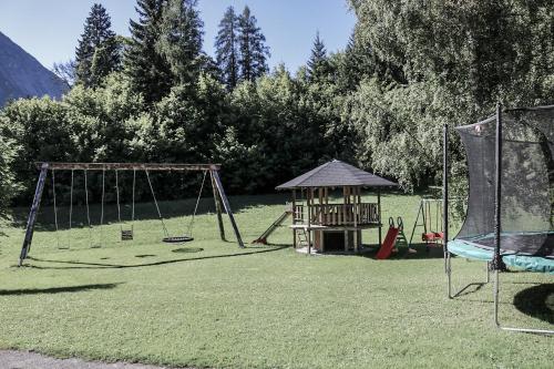 a playground with two swings and a gazebo at Vera Monti in Holzgau