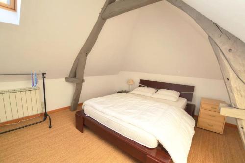 a bedroom with a large bed in an attic at La Glycine Maison 1.5 km Veulettes sur mer in Paluel