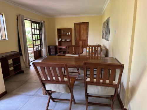 a dining room with a wooden table and chairs at Garden Beach Apartment Zanzibar in Pwani Mchangani