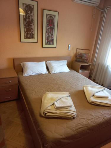 a bedroom with a bed with two towels on it at Luxury Apartments Bitola in Bitola