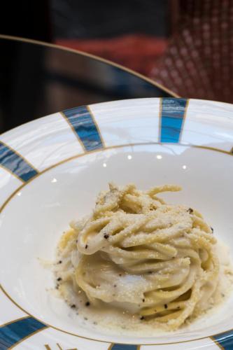 a white plate with some food on a table at Umiltà 36 in Rome