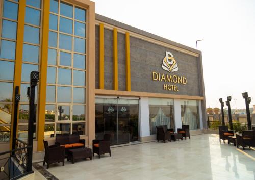 a davenport hotel with tables and chairs in front of a building at Diamond Land Hotel in Madinat Al Ashir min Ramadan