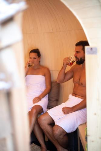 two men sitting in a tent drinking wine at DAS SCHÖNE LEBEN Pop-Up Hotel in Hornberg