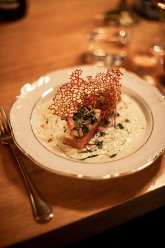 a plate of food on a wooden table at DAS SCHÖNE LEBEN Pop-Up Hotel in Hornberg