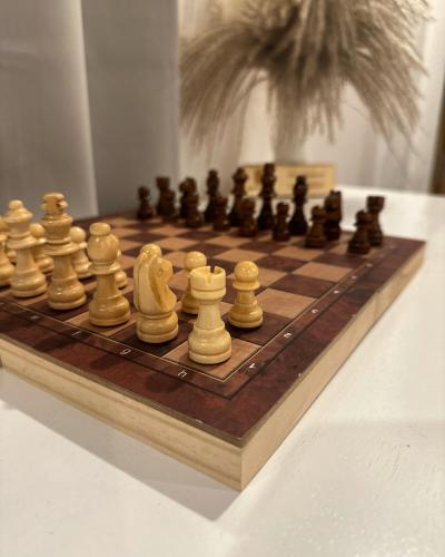a wooden chess board with chess pieces on a table at Bao Village in Haad Yao
