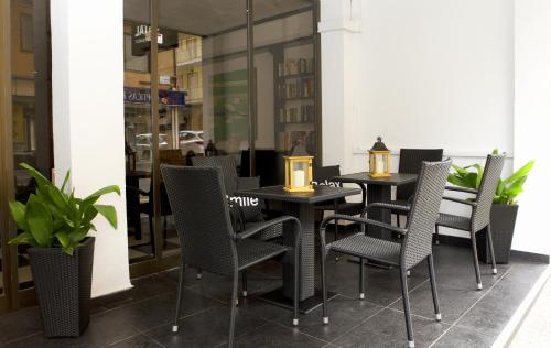 a group of chairs and tables in a restaurant at Hostal Tierramar in El Arenal