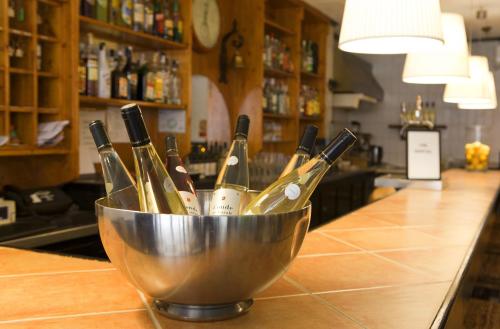 a metal bucket filled with wine bottles on a counter at Hostal Tierramar in El Arenal